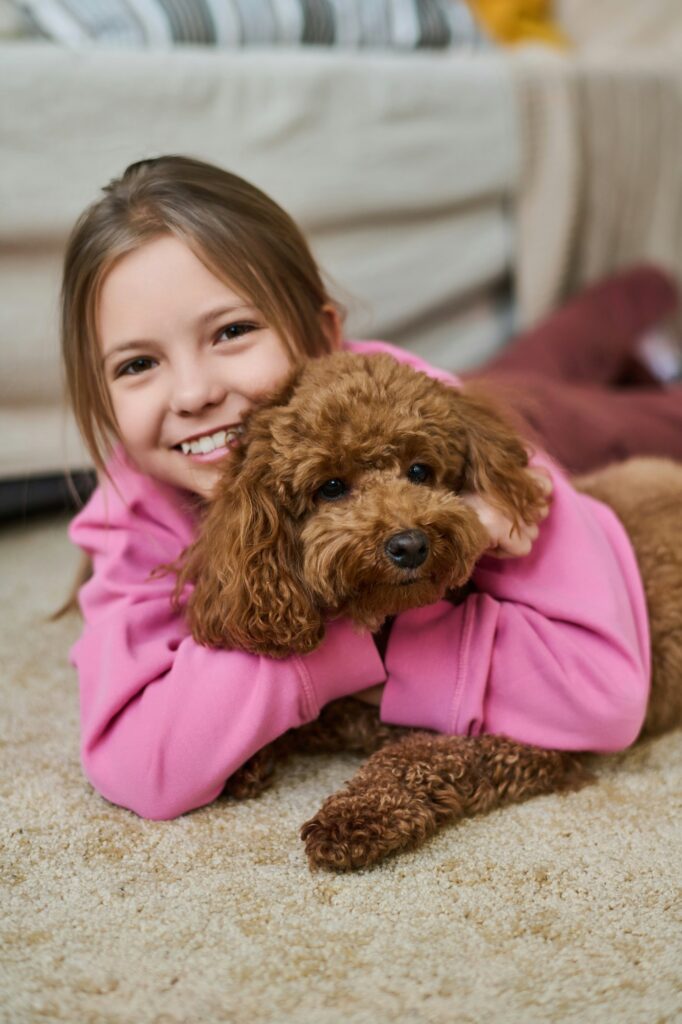 Little girl playing with her pet